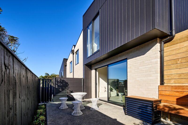 Image of rear courtyard of a two-storey townhouse in Karori